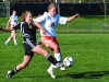 Sophomore Meghan Haun attempts to steal the ball away from SMW opponent on Apr. 12. 