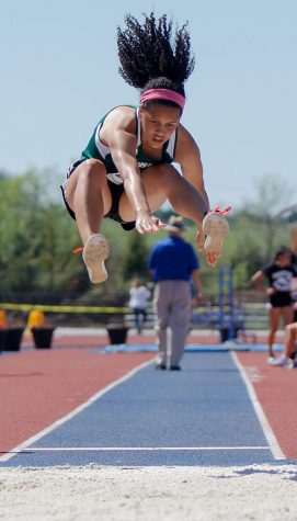 Flying through the air, sophomore Cameryn Thomas from Lawerence Free State jumps a 16' 11" for KU Relays. This jump ended her season and made a new personal record for her next upcoming season.