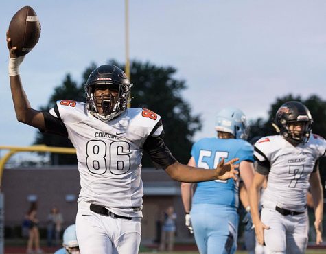 After recepting a fumble, senior Jasean Parker celebrates with the ball above his head on Sept. 8 at SM North District Stadium. The Cougars lost the the SM East Lancers 6-48. “With our team, if you don’t do something big to advance while you’re playing, everybody on the sideline kinda gives up,” Parker said. “Anytime you have a big play, it helps you get hype, so therefore, you get back on the field and play better and you start playing with motivation.”