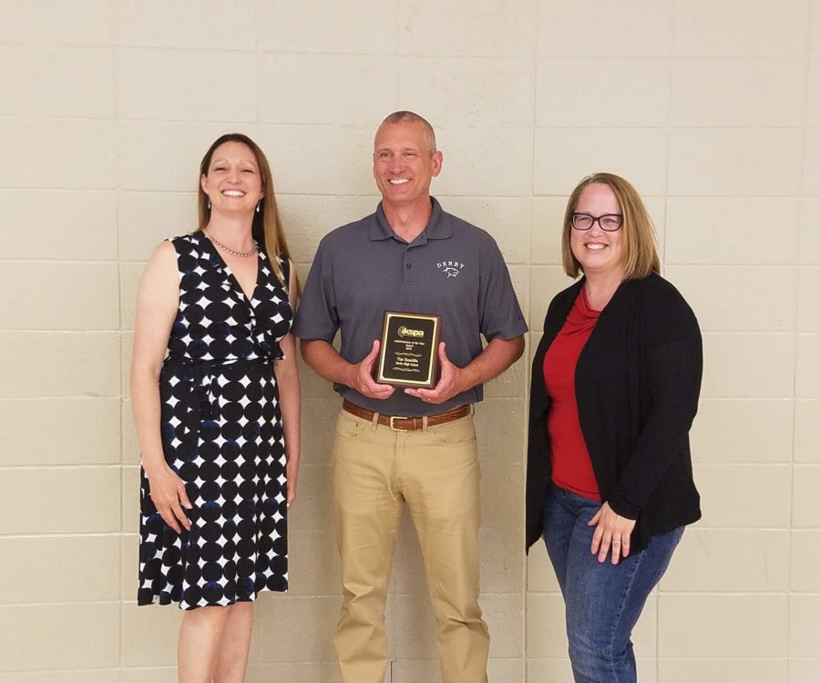 2019 KSPA Administrator of the Year Tim Hamblin poses with KSPA board president Jessica Bowman, left, and Derby High School student media adviser Joanna Chadwick, right, after an award presentation at a school board meeting in 2019.