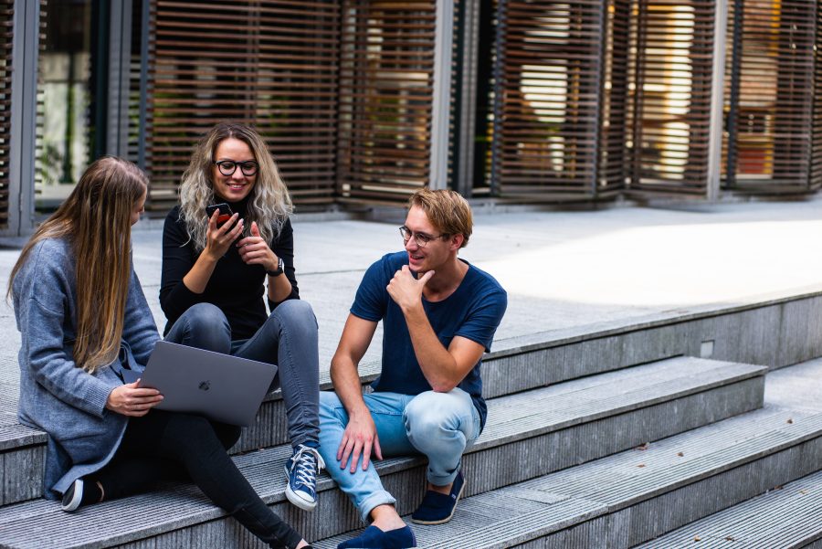 three-persons-sitting-on-the-stairs-talking-with-each-other-1438072