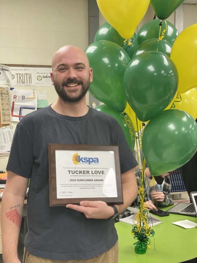 Shawnee Mission South publications adviser Tucker Love at the surprise presentation of the Sunflower Award to Love on April 4, 2022.